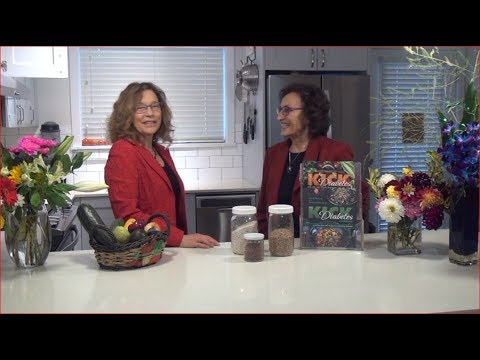 Two women discussing healthy foods in a modern kitchen for diabetes management.