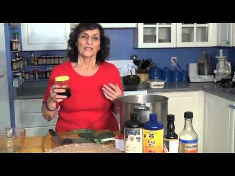 Woman cooking in kitchen with various oils and ingredients.