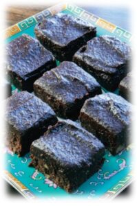 Plate of chocolate brownies on decorative dish.